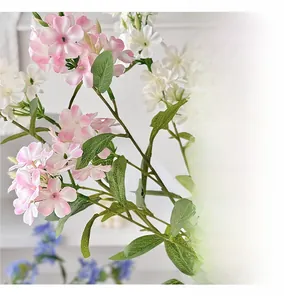 Detail of faux freesia petals with pink gradients and realistic green foliage