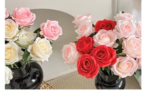 Detailed close-up of artificial rose bouquet with deep red and pink silk petals in vases