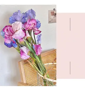 Detailed view of artificial iris flowers with blue and pink gradient petals in a basket
