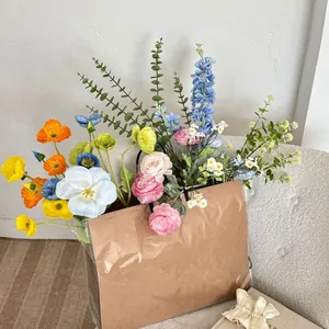 Detail of vibrant artificial poppy and rose bouquet in a kraft paper bag on a sofa