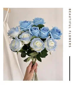 Detail of hand-held artificial rose bouquet in light blue and cream for home decor