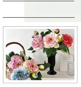 Artistic display of multicolor silk peonies in black vases and woven basket for home decor