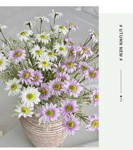 Close-up of white and purple silk daisies in a textured ceramic vase for home decor