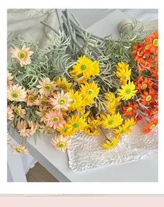 Detailed close-up of realistic silk daisy bouquet in pink, yellow and orange tones