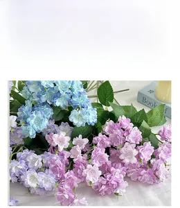 Close-up detail of realistic artificial silk flower bouquet in pastel blue and purple tones