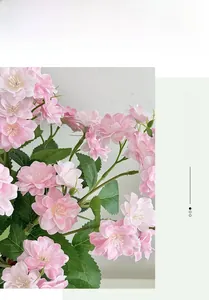 Macro detail of artificial pink jasmine with realistic petals and green foliage decor