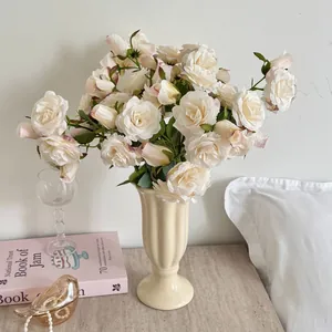 Roses en soie blanc crème aux bords roses dans un vase vintage en céramique
