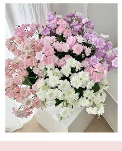 Detail of elegant pink and white silk jasmine bouquet on a modern white display stand
