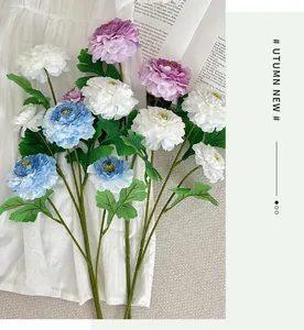 Macro view of artificial peony flowers in purple and white on a vintage book