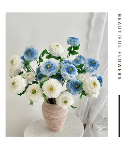 Close-up of white and blue artificial peonies in a matte brown ceramic vase for decor