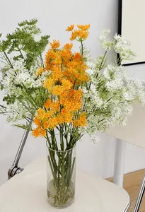 Detailed view of Queen Anne's Lace artificial flowers in white and orange tones