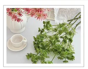 Detailed view of vibrant artificial lace flowers and greenery in a modern living room setting