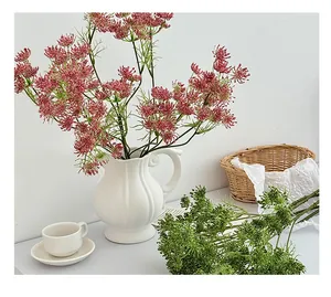 Detail of pink and green artificial Ammi majus flowers in a vintage white ceramic vase