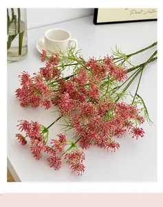 Detailed view of red and white artificial gypsophila flowers in a cozy home setting