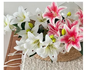 Close-up of lifelike pink and white lily flowers with realistic green buds in a woven basket