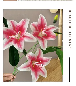 Close-up of artificial pink lily bouquet with two blooming flowers and one bud