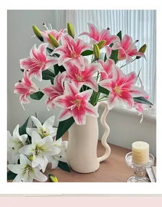 Detail of pink and white faux lily flowers in a wavy handle ceramic vase for home decor