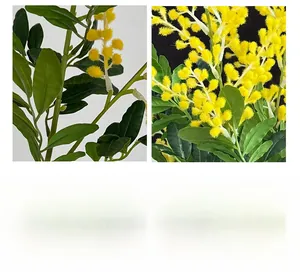 Détail de fleurs d'acacia en peluche jaune et feuilles vertes sur branches artificielles
