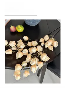 Detail view of realistic artificial winter cherry branches for home floral decoration