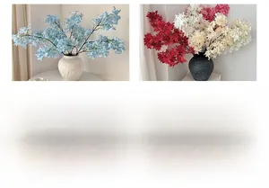 Detailed view of artificial lilac flowers in white ceramic and gray frosted vases