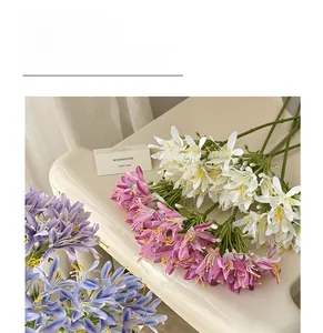 Detailed view of artificial agapanthus silk flowers in white, purple, and light blue colors