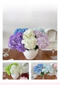Detail of silk hydrangea bouquets in various colors with textured ceramic and metal vases
