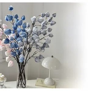 Modern faux blue and white bellflowers in a glass vase for stylish home table decoration