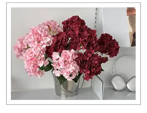 Pink and burgundy faux hydrangeas in a silver metal bucket for elegant home decor