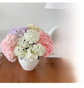 Detailed view of artificial hydrangea bouquet in white ceramic vase for home decor
