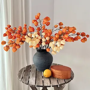Artificial lantern fruit branches in a black ceramic vase for elegant home floral decor