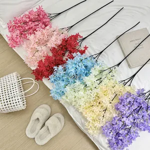 Artificial lilac cherry blossoms in various colors arranged for elegant home decor