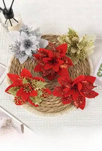 Close-up of glitter-dusted artificial poinsettia flowers for Christmas wreaths and decor