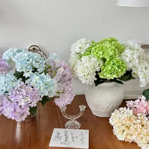 Vibrant multicolored faux hydrangea bouquet in elegant ceramic vase for wedding decor