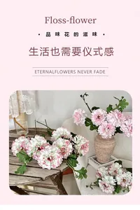 Detailed view of artificial pink hibiscus peony flowers in a ceramic vase on a wooden table