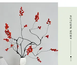 Macro detail of artificial red berries and white ceramic vase for Zen home decor