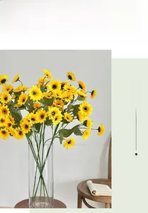 Detailed view of artificial sunflowers in a glass vase for home interior decoration