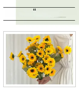 Detailed view of artificial sunflower bouquet held by a person in bright lighting
