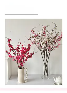 Realistic artificial plum blossom branches in red and white colors for home decoration