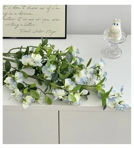 Detail of realistic blue and white sweet pea artificial flowers for home decor