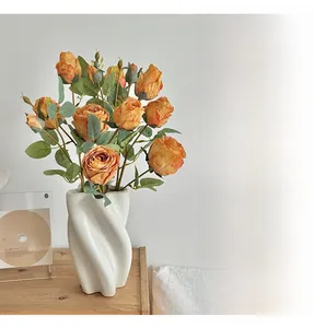 French retro orange silk roses in a white spiral ceramic vase for home decor