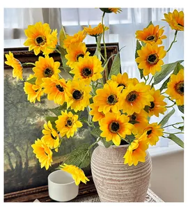 Close-up of artificial sunflower bouquet in a ceramic vase with vintage home decor