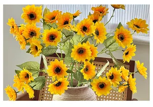 Detailed close-up of vibrant yellow artificial sunflower bouquet in a ceramic vase