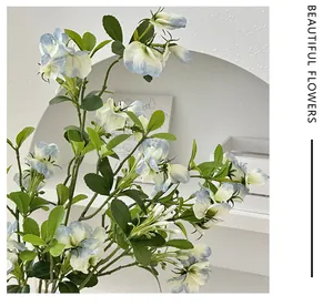 Close-up of blue and white gradient sweet pea silk flowers in minimalist home decor
