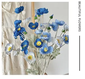 Detailed view of silk poppy petals and flocked stems in blue and white colors