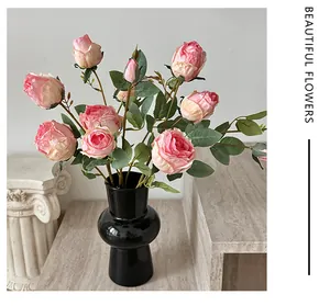 French oil painting style pink silk roses in a modern black vase on marble steps