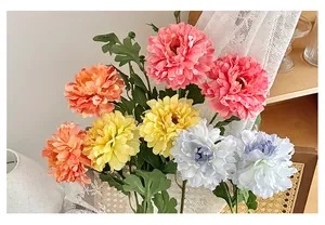 Macro shot of realistic silk dahlia bouquet with lush petals on white lace and rattan chair