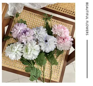Macro shot of artificial peony bouquet on vintage rattan chair with white lace details