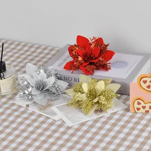 Sparkling artificial poinsettia flowers in red, gold, and silver for Christmas tree decor
