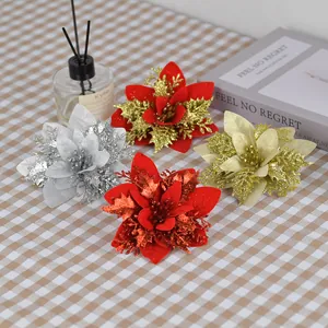 Glittery artificial Christmas flowers in gold and red for tree decoration and wreaths