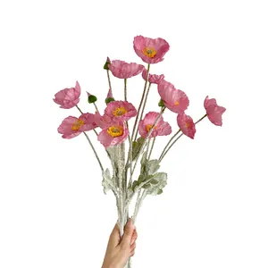 Hand-held pink artificial Icelandic poppies with realistic flocked stems on white background